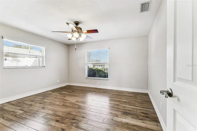 a view of a room with wooden floor and window