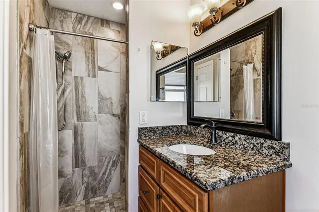 an aerial view of residential houses with outdoor space and parking