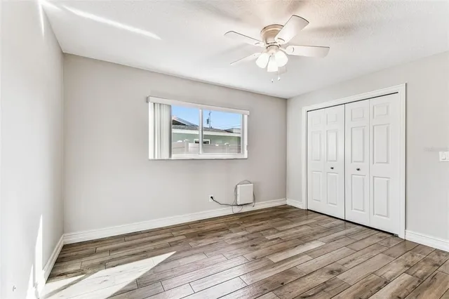 an aerial view of residential houses with outdoor space and trees