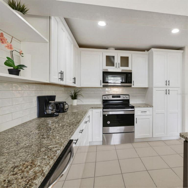 1202 Princeton Road Cocoa, FL 32922 - Photo 13 of 15 a kitchen with granite countertop a stove and a sink