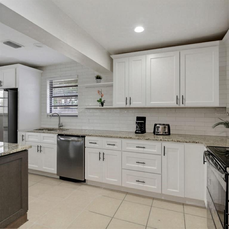1202 Princeton Road Cocoa, FL 32922 - Photo 14 of 15 a kitchen with cabinets appliances a sink and a counter top space