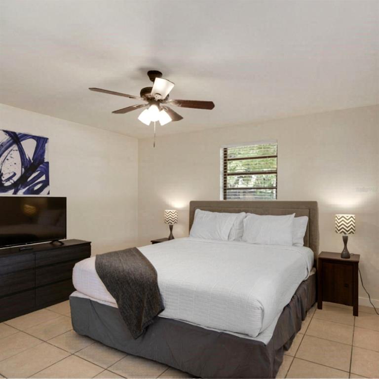 1202 Princeton Road Cocoa, FL 32922 - Photo 7 of 15 a bedroom with a large bed and a tv