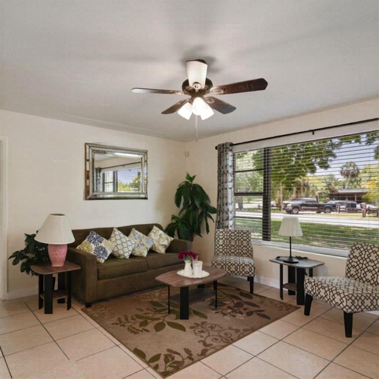 1202 Princeton Road Cocoa, FL 32922 - Photo 9 of 15 a living room with furniture and a large window