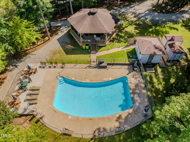 a view of a swimming pool with a yard