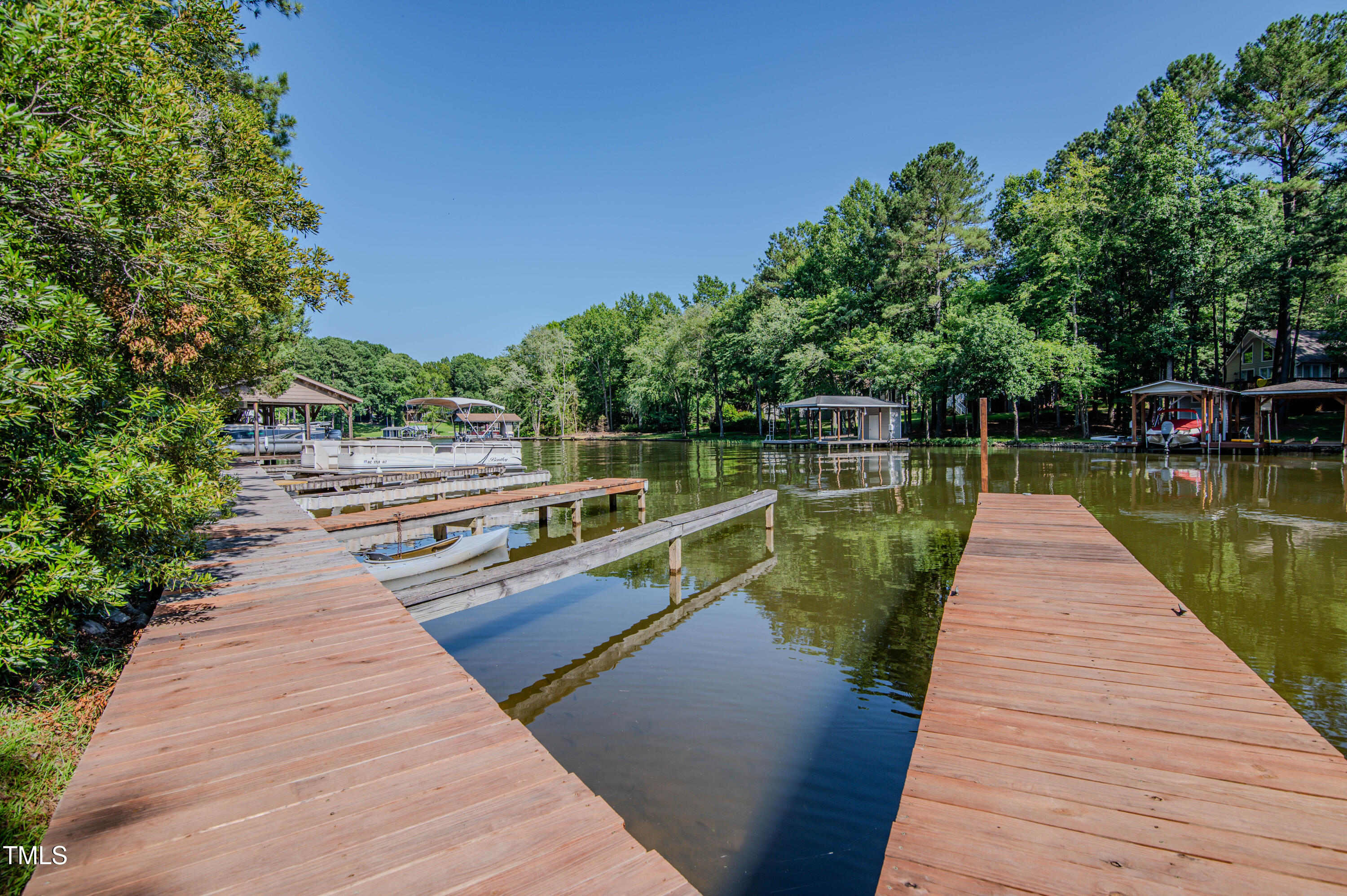Lot 6 Rabbit Bottom Circle Littleton, NC 27850 - Photo 29 of 39 a view of wooden deck and lake with trees in the background