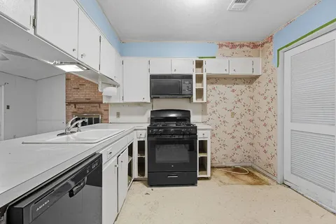 a kitchen with stainless steel appliances granite countertop a stove and a microwave