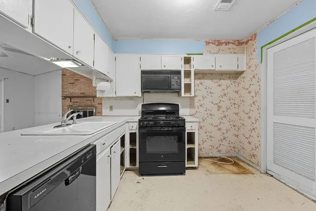 a kitchen with stainless steel appliances granite countertop a stove and a microwave