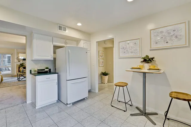 a kitchen with stainless steel appliances a refrigerator and a stove
