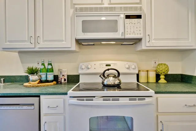 a stove top oven sitting inside of a kitchen