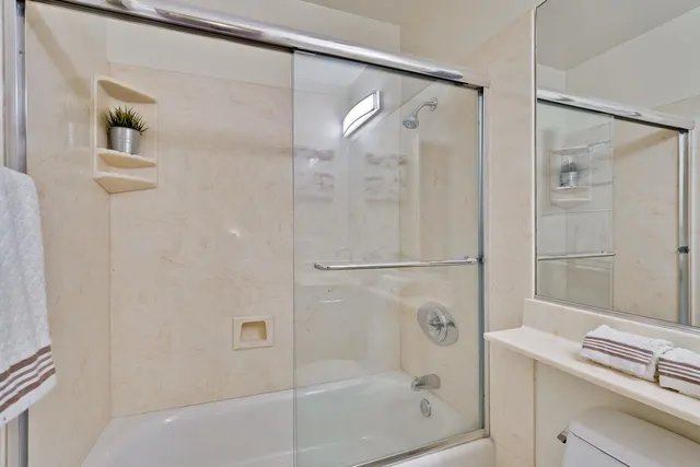 a bedroom with a bed and a potted plant