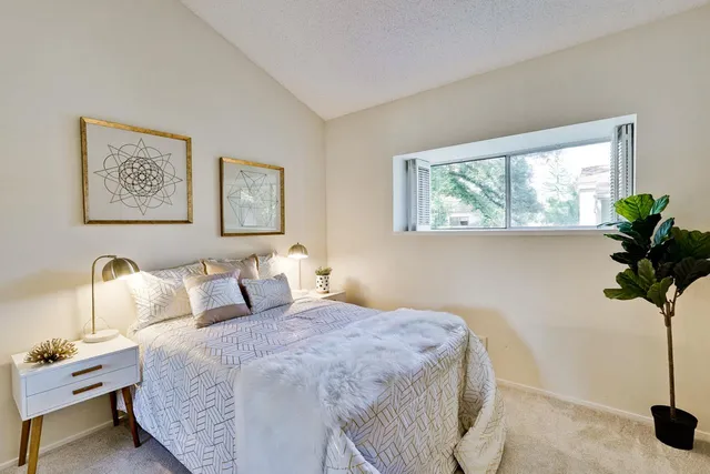 a bedroom with bed and window