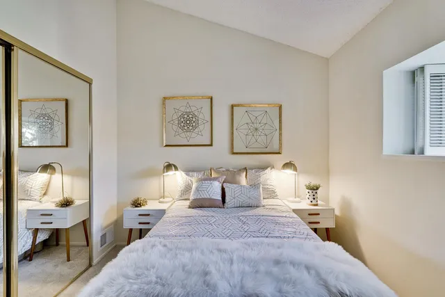 a bedroom with a bed and a table