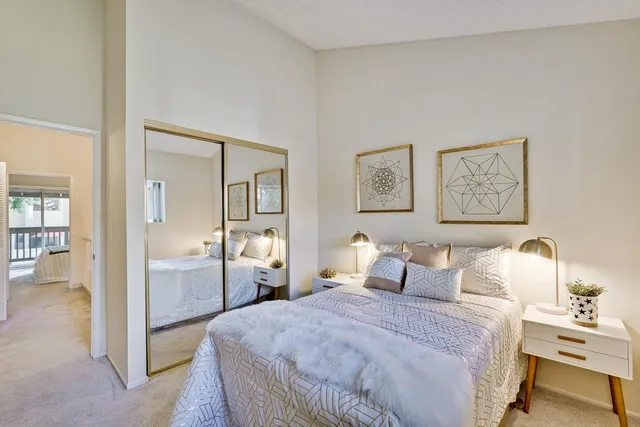 a bedroom with a bed and a plant