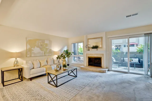 a living room with furniture and a fireplace