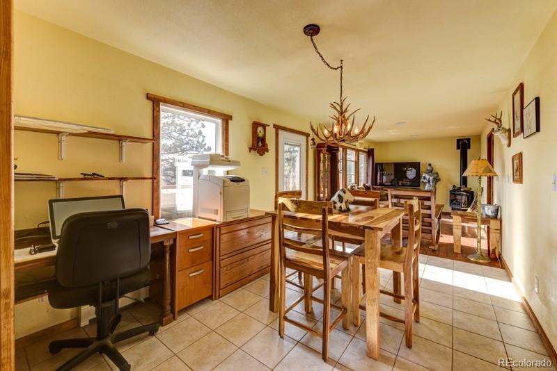 11773 Hillcrest Road Golden, CO 80403 - Photo 9 of 34 a view of a dining room with furniture and a chandelier