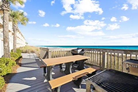 a view of a balcony with wooden floor and fence