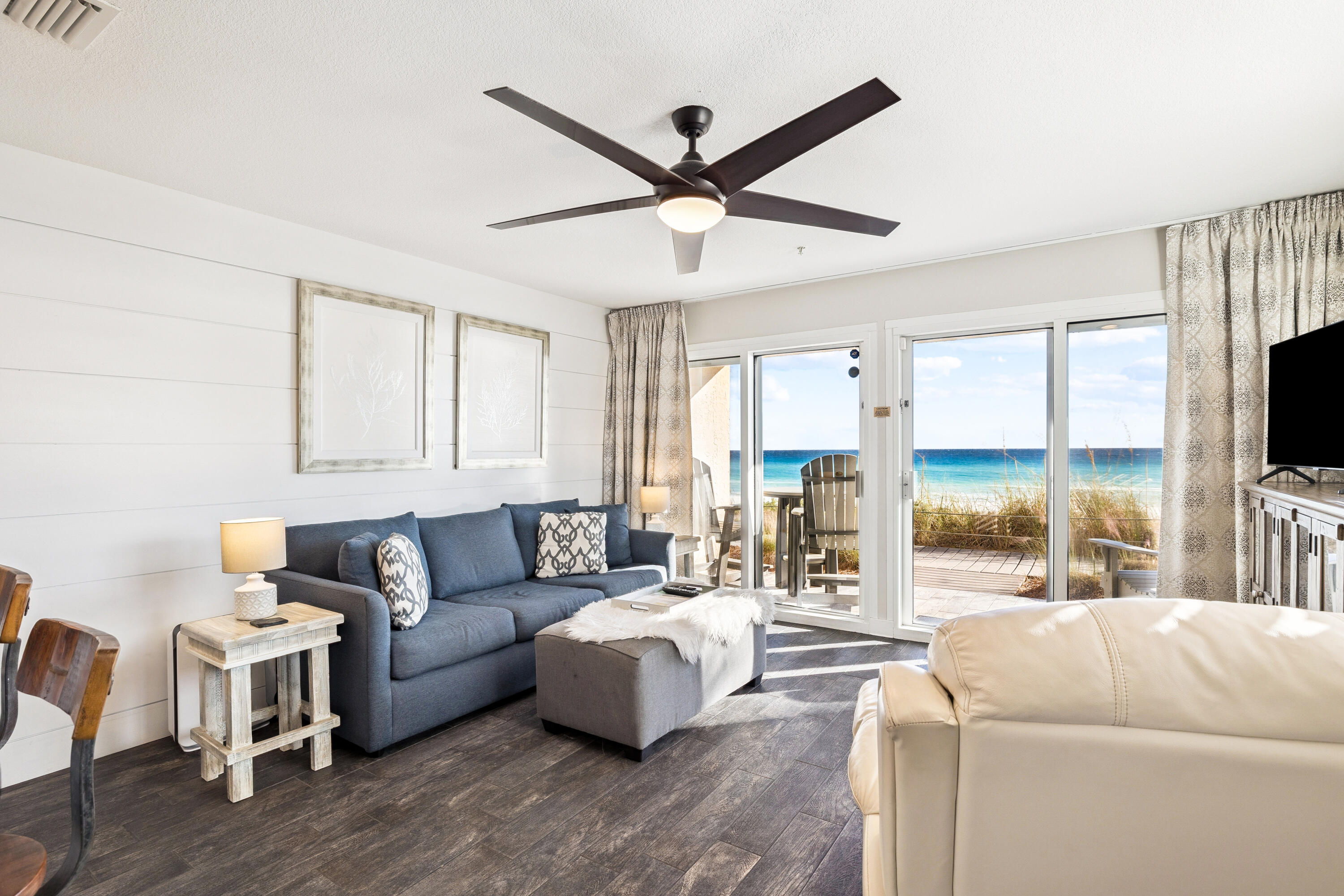 3184 East Scenic Highway 98, Unit 116A Destin, FL 32541 - Photo 5 of 29 a living room with furniture floor to ceiling window and a flat screen tv