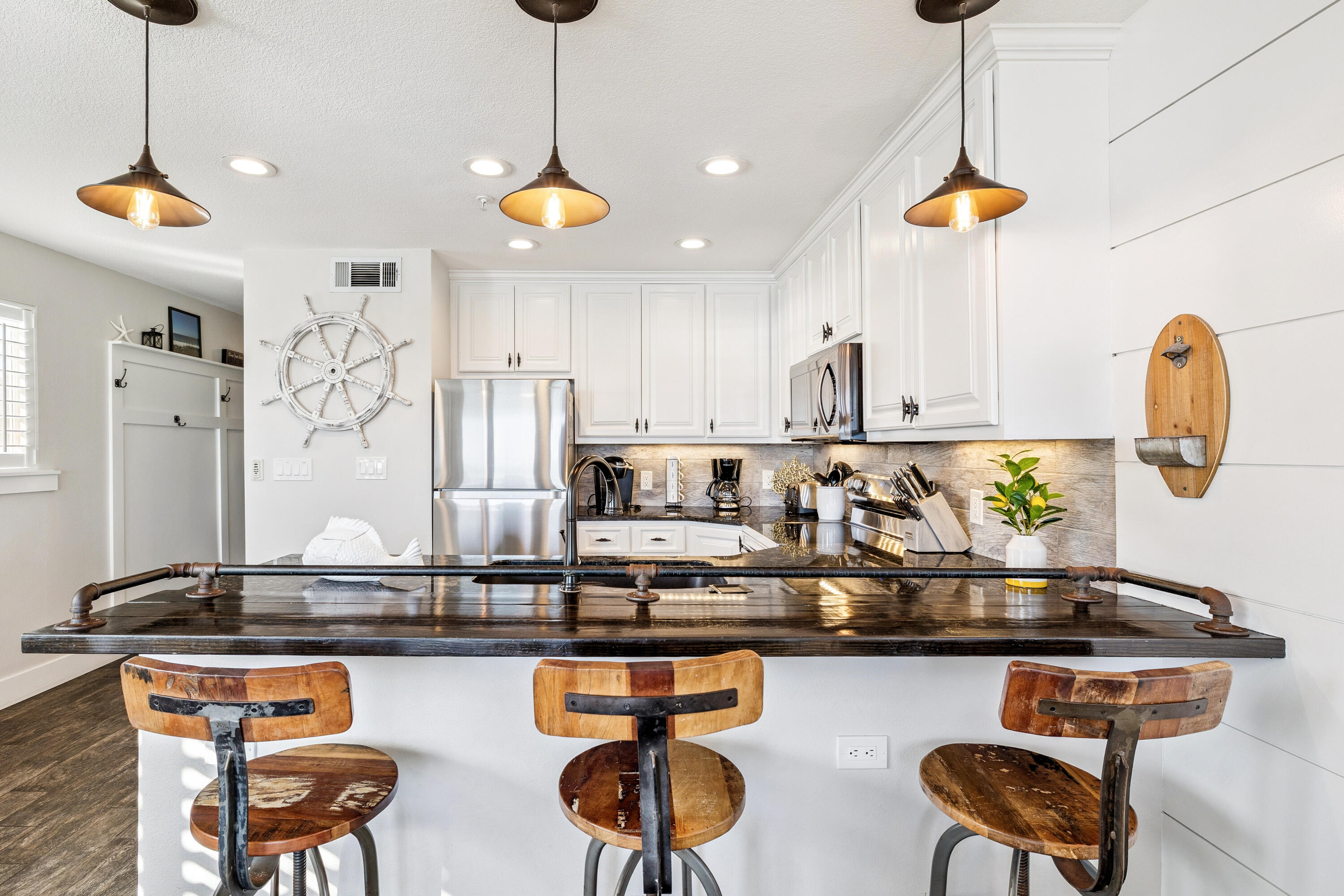 3184 East Scenic Highway 98, Unit 116A Destin, FL 32541 - Photo 7 of 29 a kitchen with stainless steel appliances granite countertop a sink a stove and a wooden floor