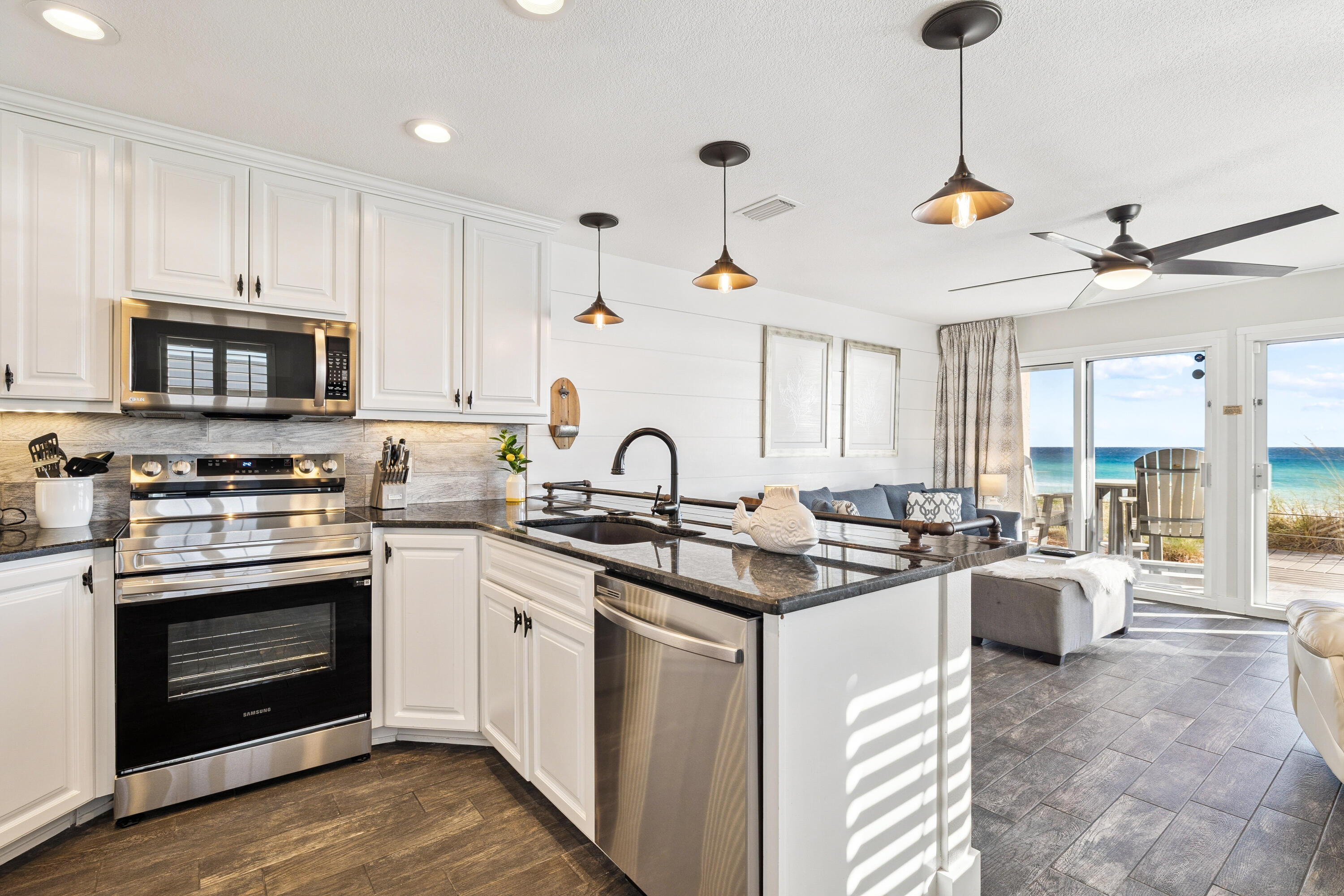 3184 East Scenic Highway 98, Unit 116A Destin, FL 32541 - Photo 10 of 29 a kitchen with stainless steel appliances granite countertop a stove a sink dishwasher a refrigerator and a stove