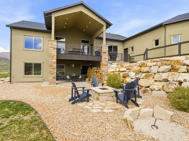 402 Shadow Hill Road Wanship, UT 84017 - Photo 68 of 90 Rear view of property featuring a patio, stucco siding, a fire pit, and a balcony