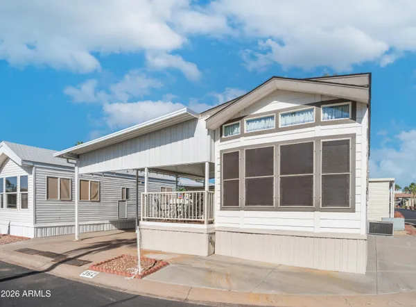 a view of a patio with table and chairs potted plants with wooden floor