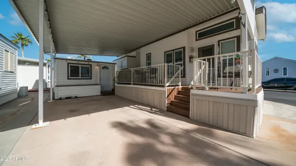a view of a house with a yard table and chairs