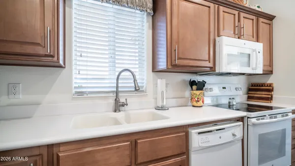 a kitchen with appliances cabinets and a sink