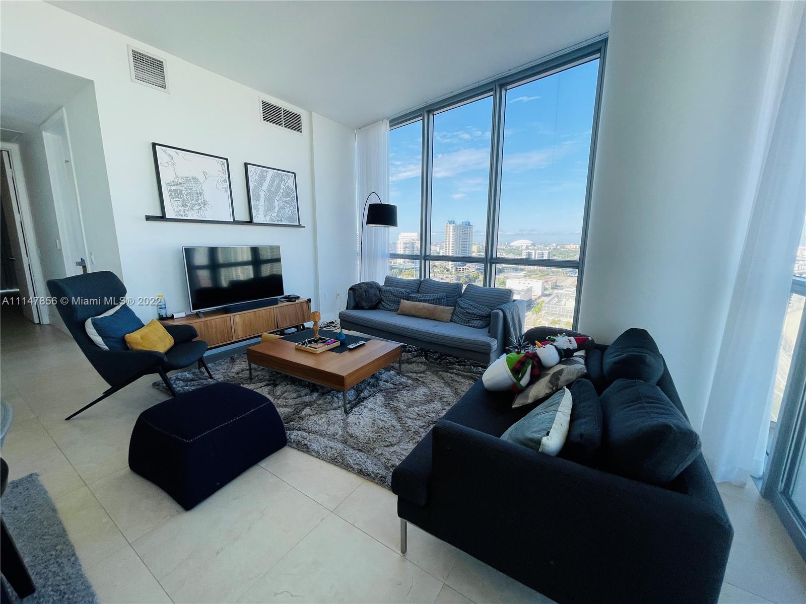 a living room with furniture rug and a fireplace