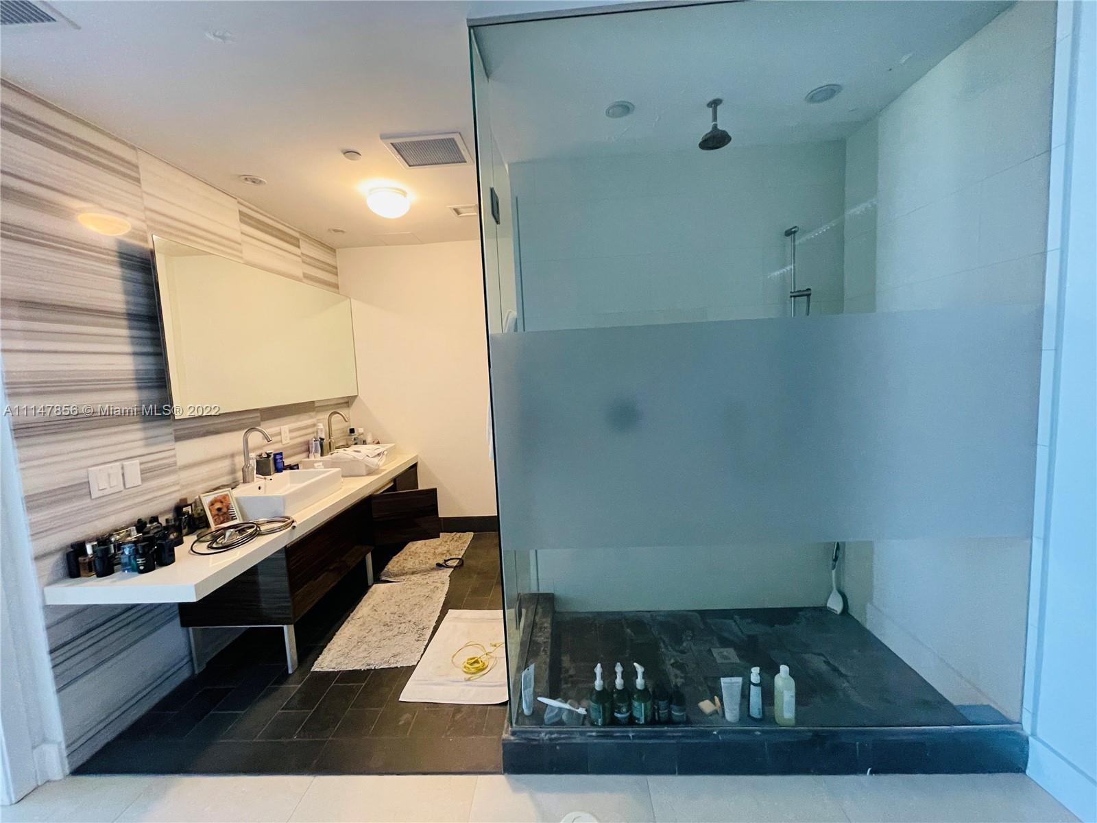 1100 Biscayne Boulevard, Unit 2003 Miami, FL 33132 - Photo 15 of 24 a bathroom with a sink and a mirror