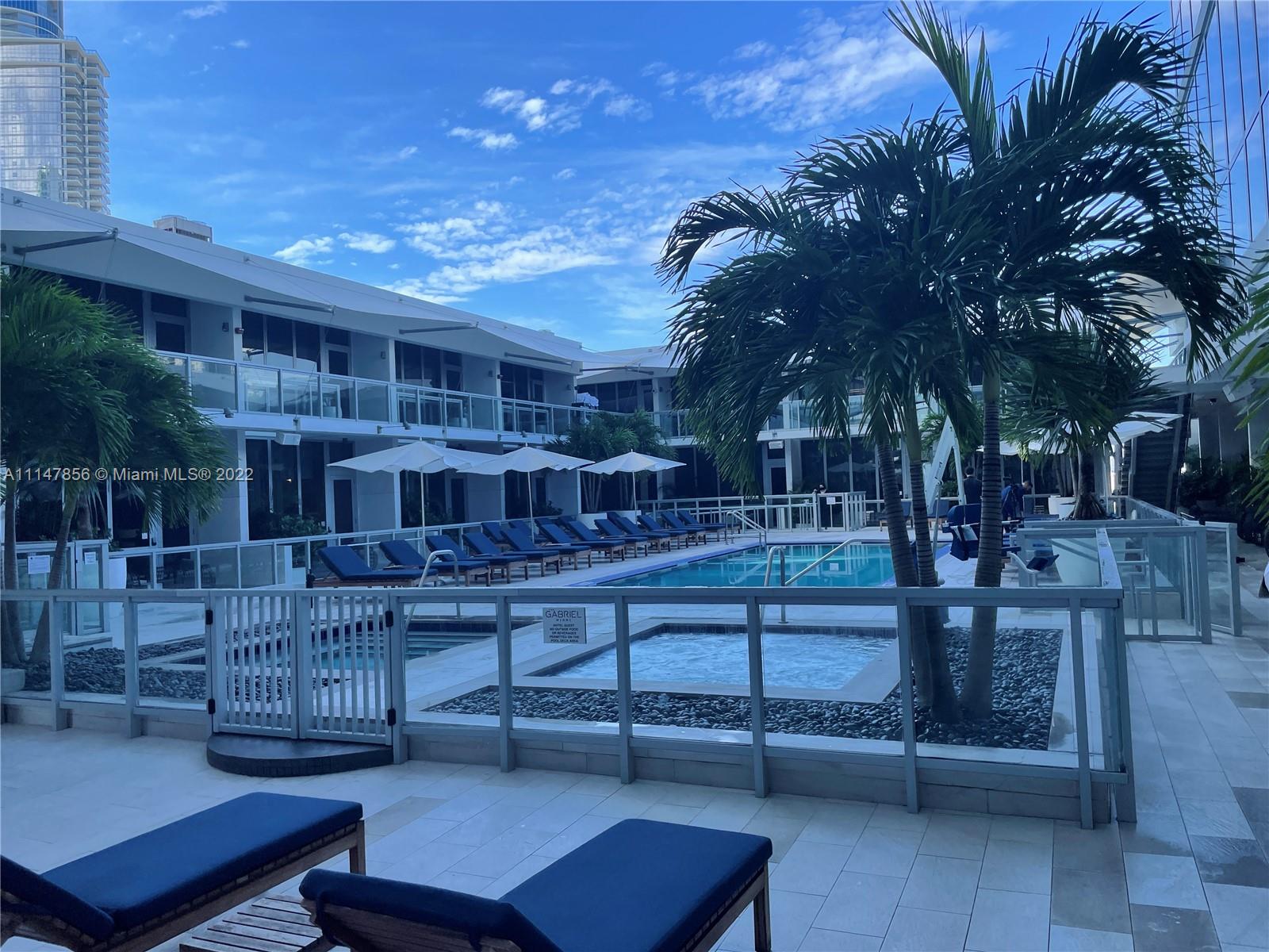 1100 Biscayne Boulevard, Unit 2003 Miami, FL 33132 - Photo 16 of 24 a view of a chairs and table in the patio