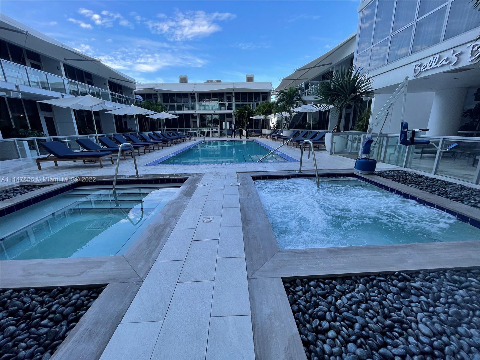 1100 Biscayne Boulevard, Unit 2003 Miami, FL 33132 - Photo 17 of 24 a living room with lots of furniture and clutter