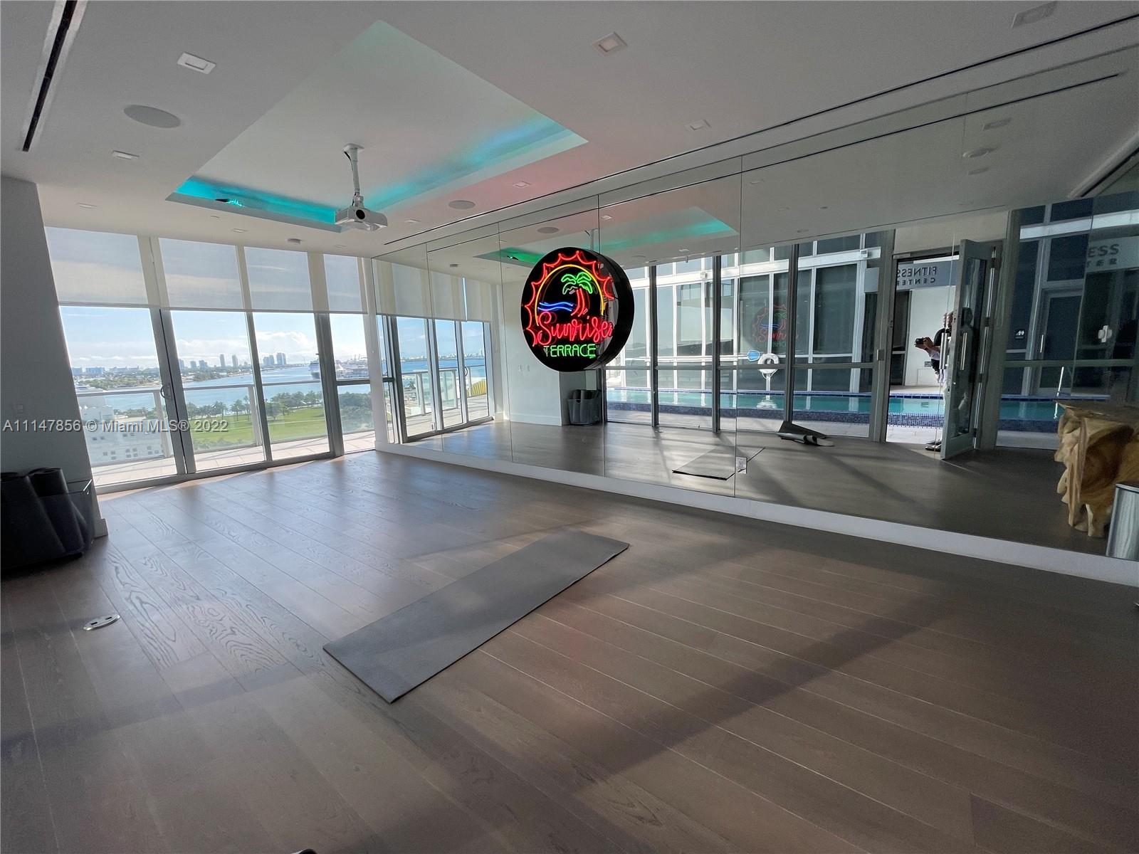 1100 Biscayne Boulevard, Unit 2003 Miami, FL 33132 - Photo 19 of 24 an empty room with wooden floor and windows