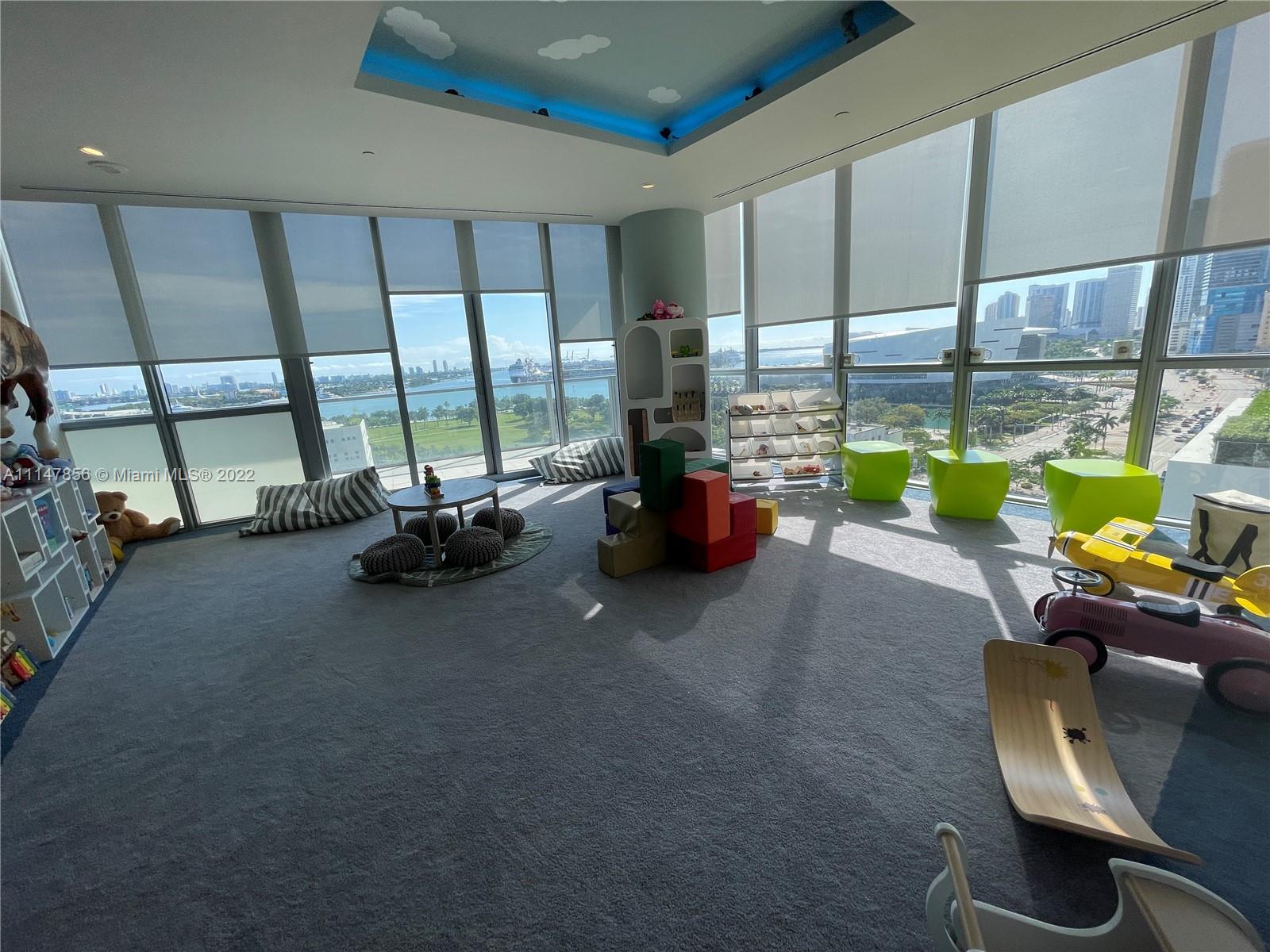 1100 Biscayne Boulevard, Unit 2003 Miami, FL 33132 - Photo 20 of 24 a living room with furniture and a floor to ceiling window