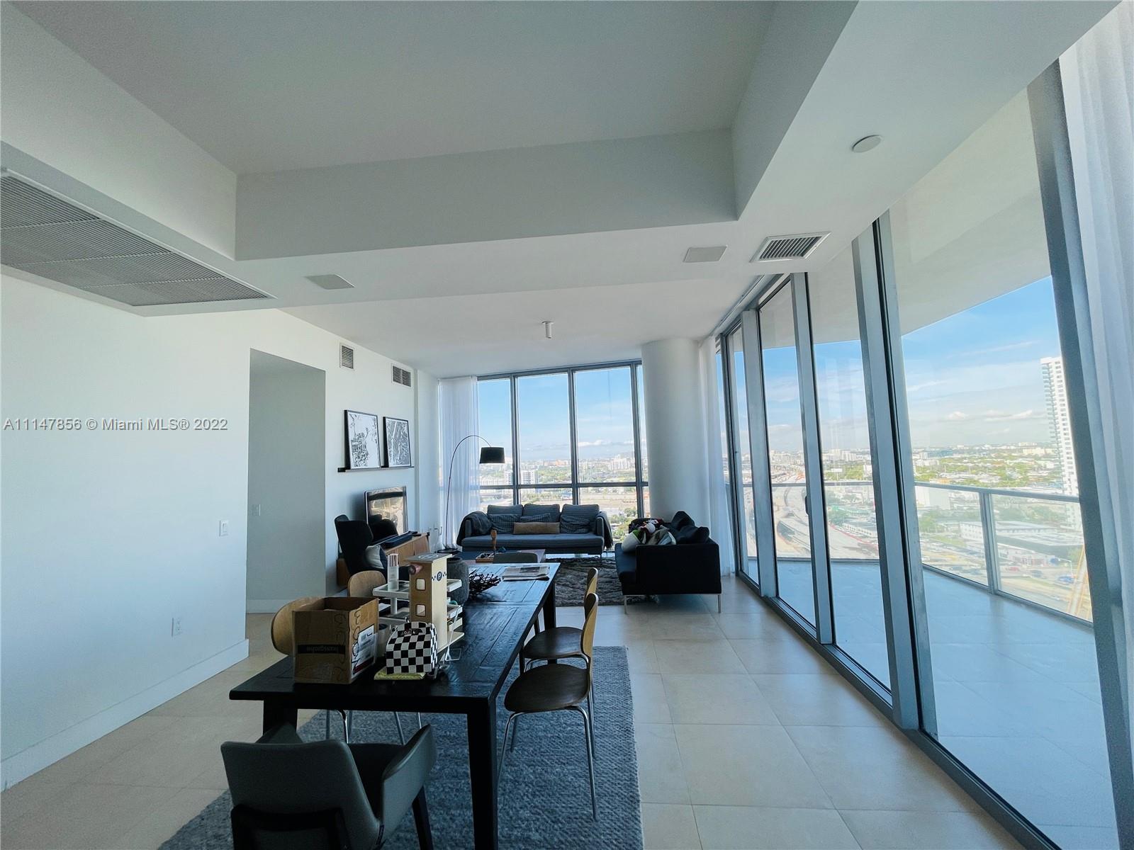 1100 Biscayne Boulevard, Unit 2003 Miami, FL 33132 - Photo 5 of 24 a living room with furniture and a window
