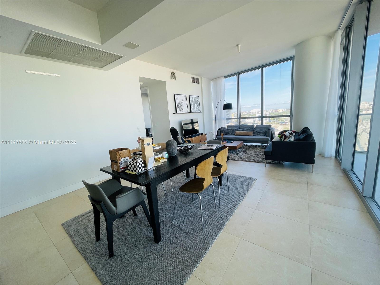 1100 Biscayne Boulevard, Unit 2003 Miami, FL 33132 - Photo 6 of 24 a living room with furniture and a window