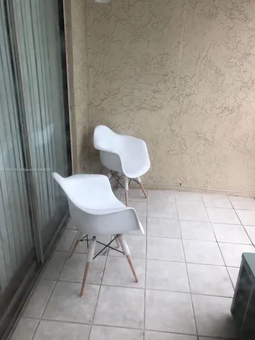 a view of a room with a table and chairs
