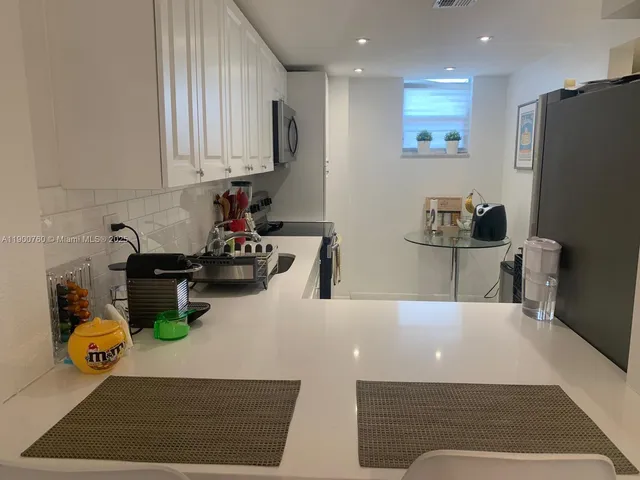 a kitchen with a sink and a stove top oven