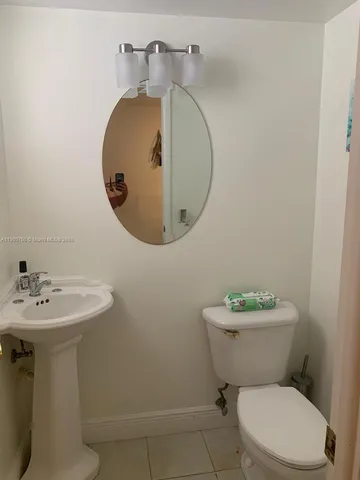 a white toilet sitting next to a bathroom sink