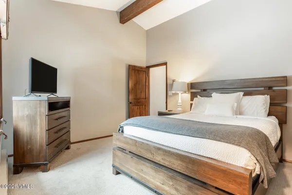a bedroom with a bed and a flat screen tv