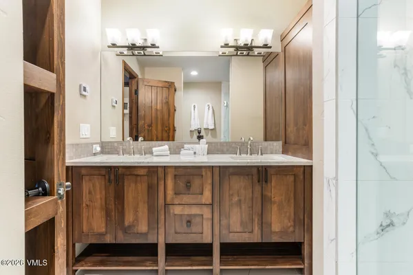 a bathroom with a double vanity sink and a mirror