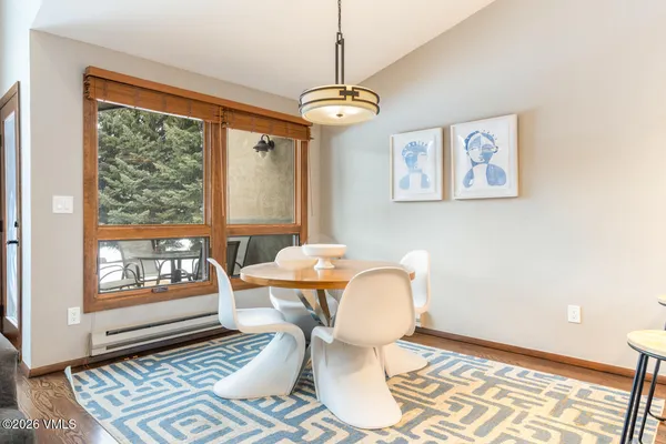 a dining room with furniture and window