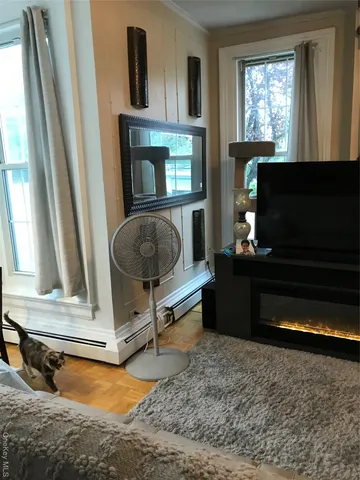 a living room with furniture fireplace and window