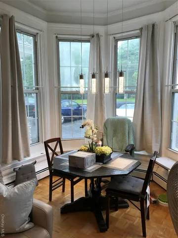 a view of a dining room with furniture and window