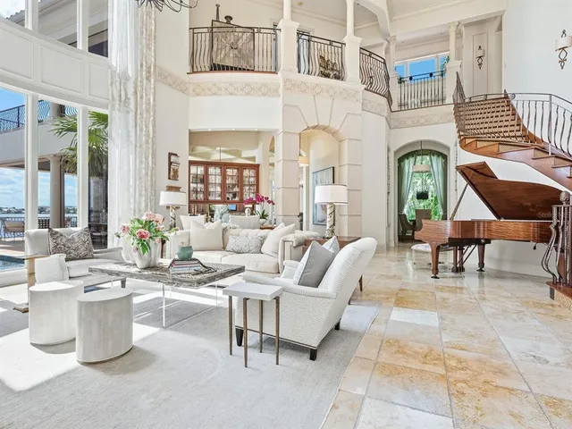 a spacious bedroom with a bed a chandelier and a dresser