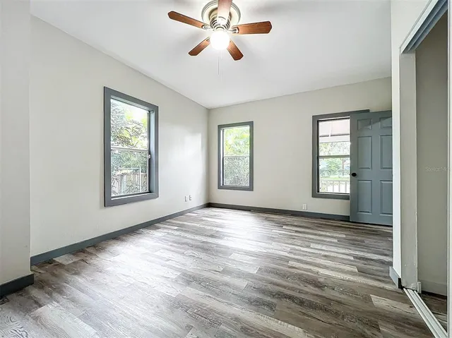 wooden floor in an empty room with a window