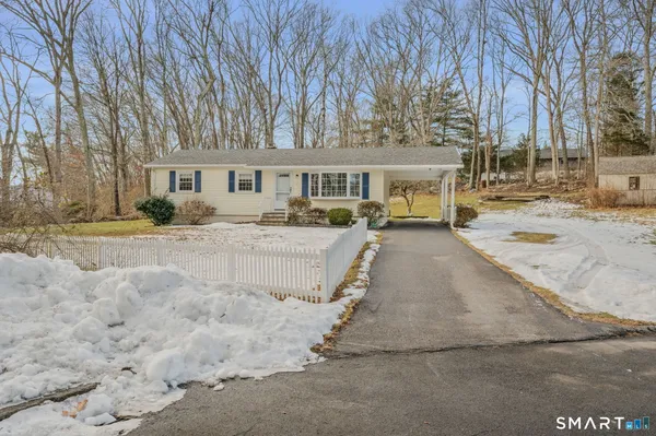 a view of a house with a yard covered in snow