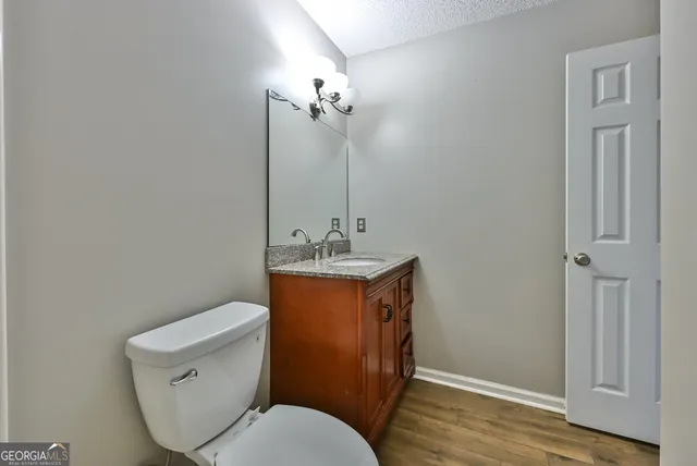 a bathroom with a toilet sink and vanity