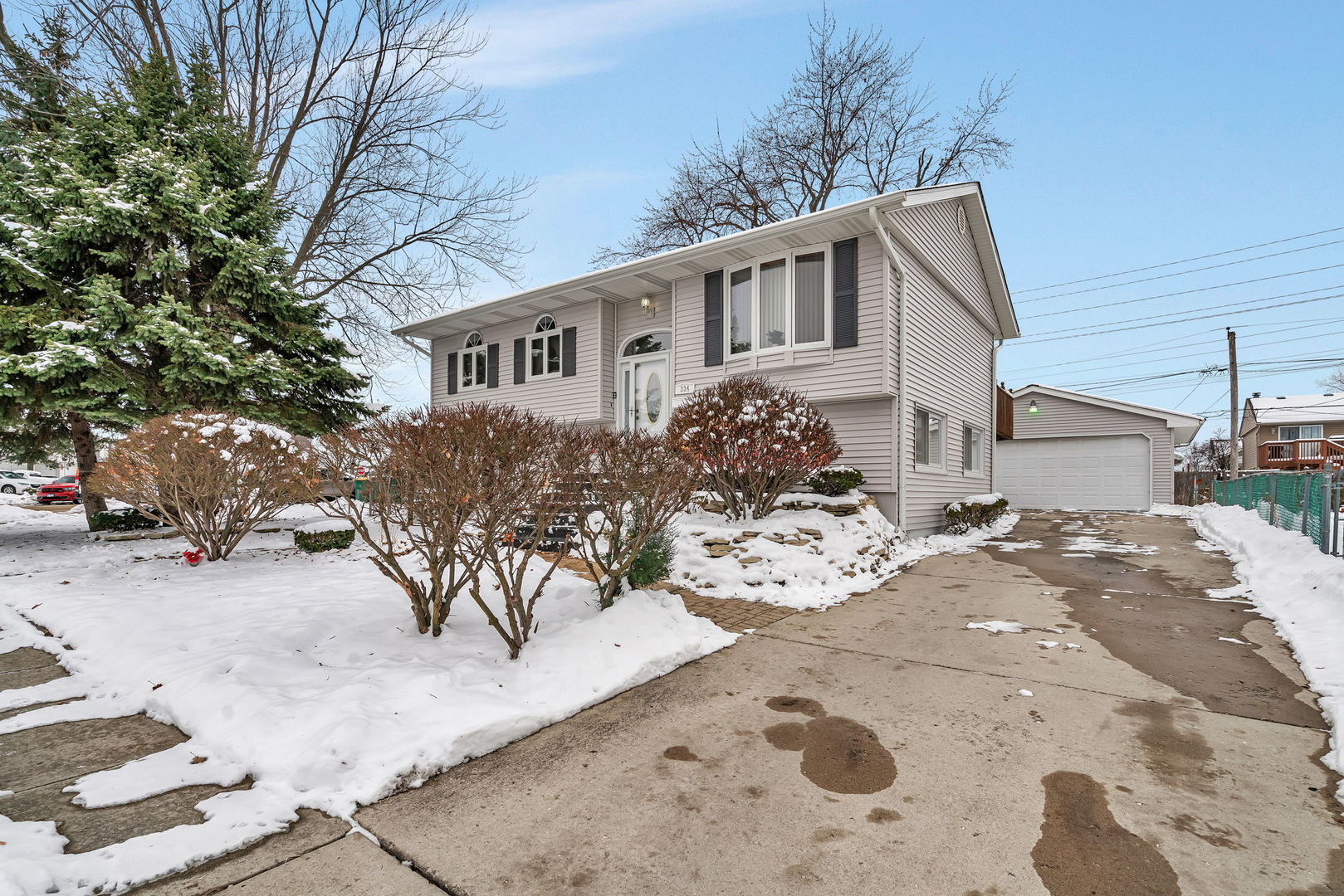 334 Hemlock Avenue Romeoville, IL 60446 - Photo 1 of 24 a view of a house with a yard covered in snow