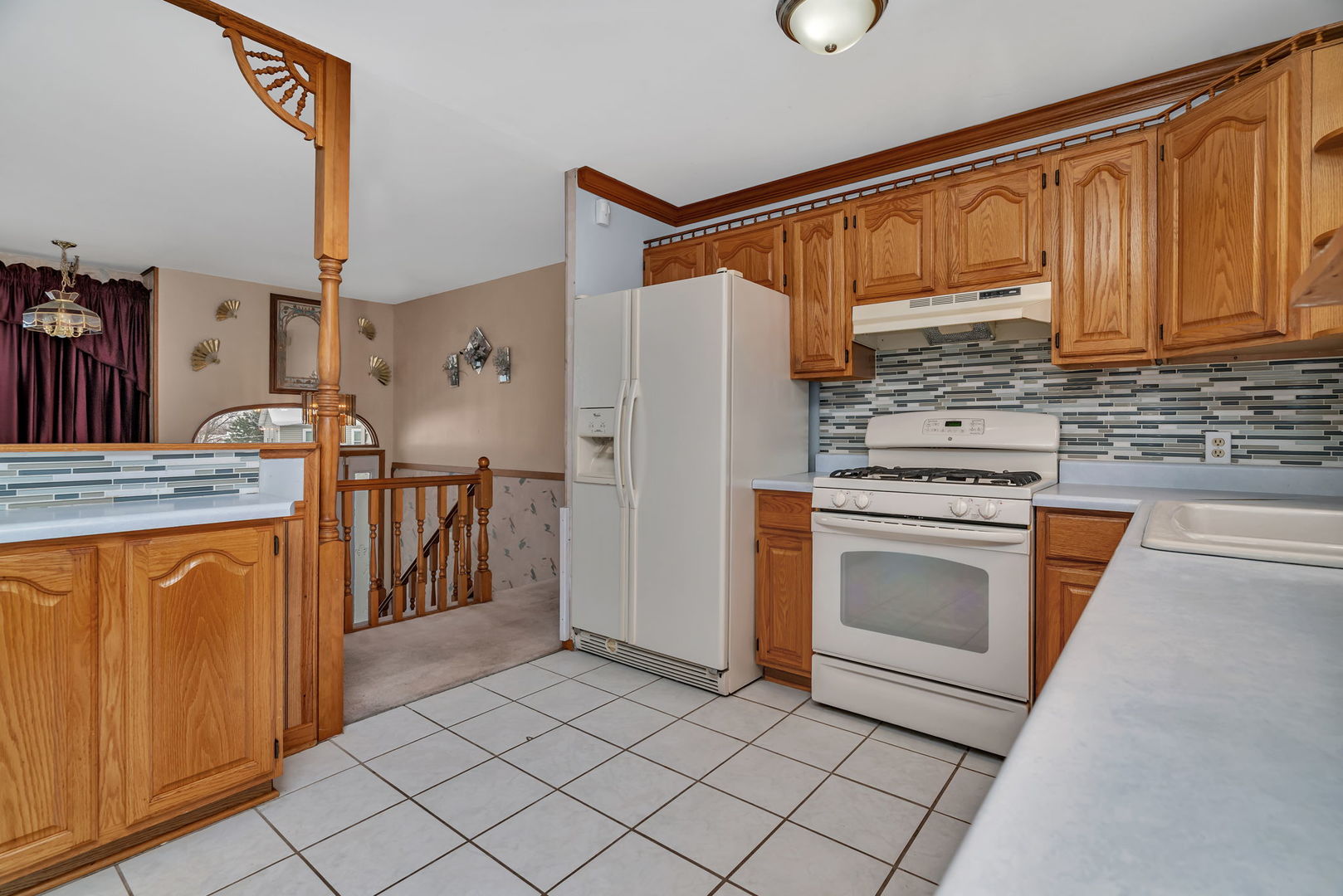 334 Hemlock Avenue Romeoville, IL 60446 - Photo 6 of 24 a kitchen with stainless steel appliances granite countertop a refrigerator sink and stove