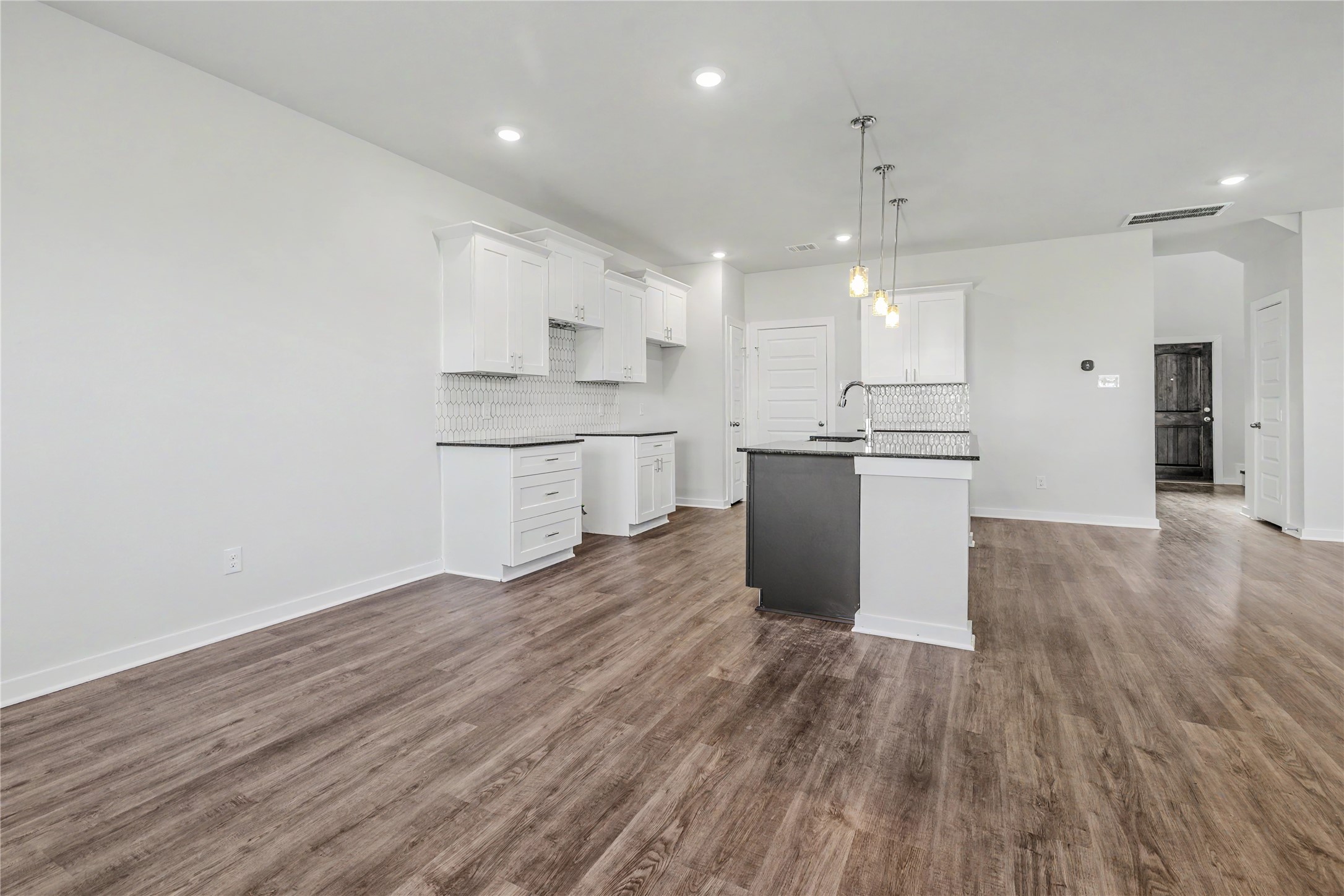 6426 Bolinas Court Rosharon, TX 77583 - Photo 22 of 49 a kitchen with stainless steel appliances granite countertop a sink stove and wooden floor
